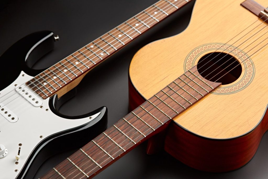 modern-electric-and-retro-acoustic-guitars-closeup-e1649228175195.jpg